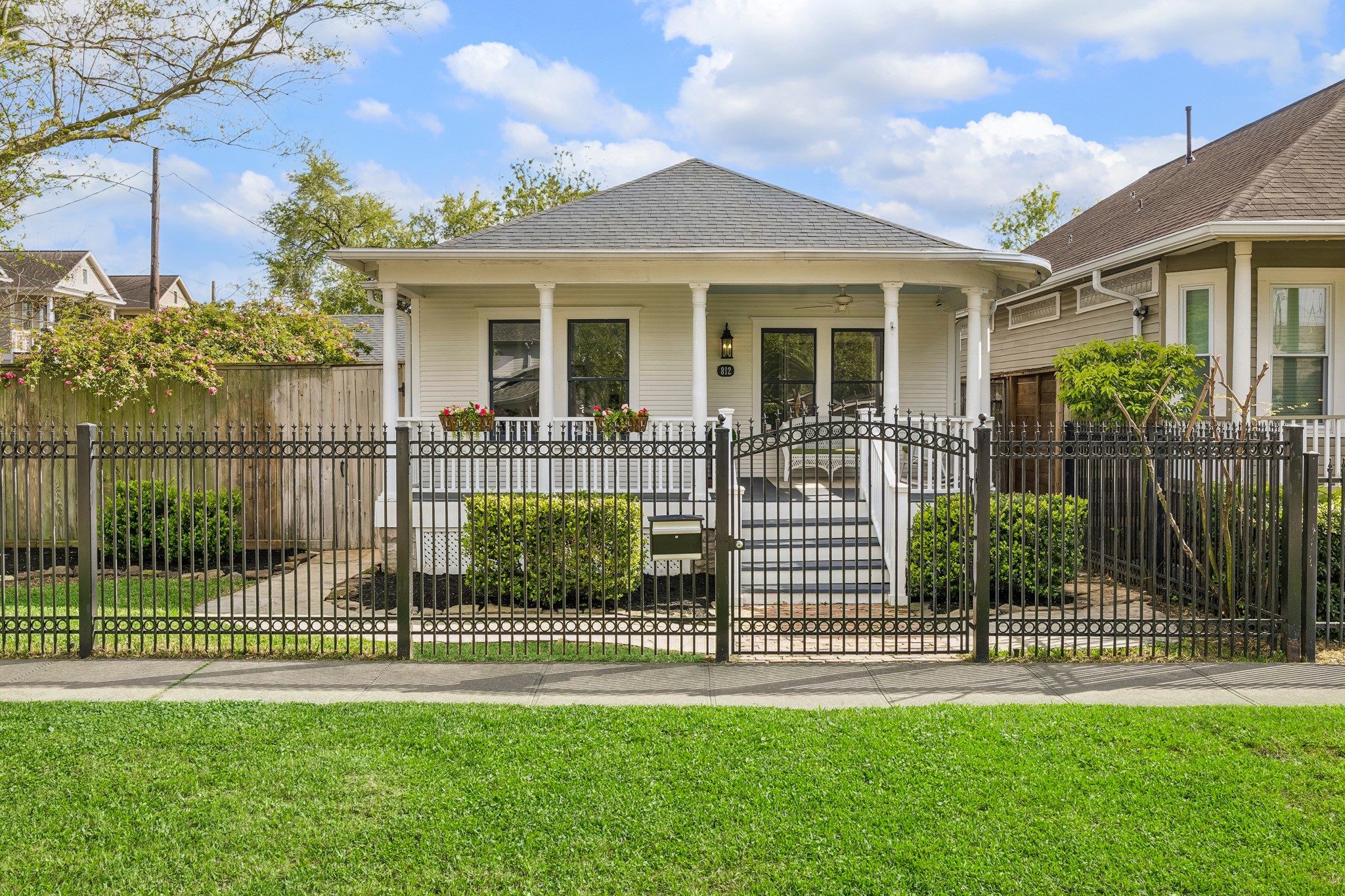 812 West 13th Street Houston, TX 77008 - Photo 7 of 29 Charming single-story home with a welcoming front porch, white exterior, and decorative fencing. It features well-maintained landscaping and is situated in a cozy neighborhood setting. Perfect for those seeking a quaint and inviting residence.