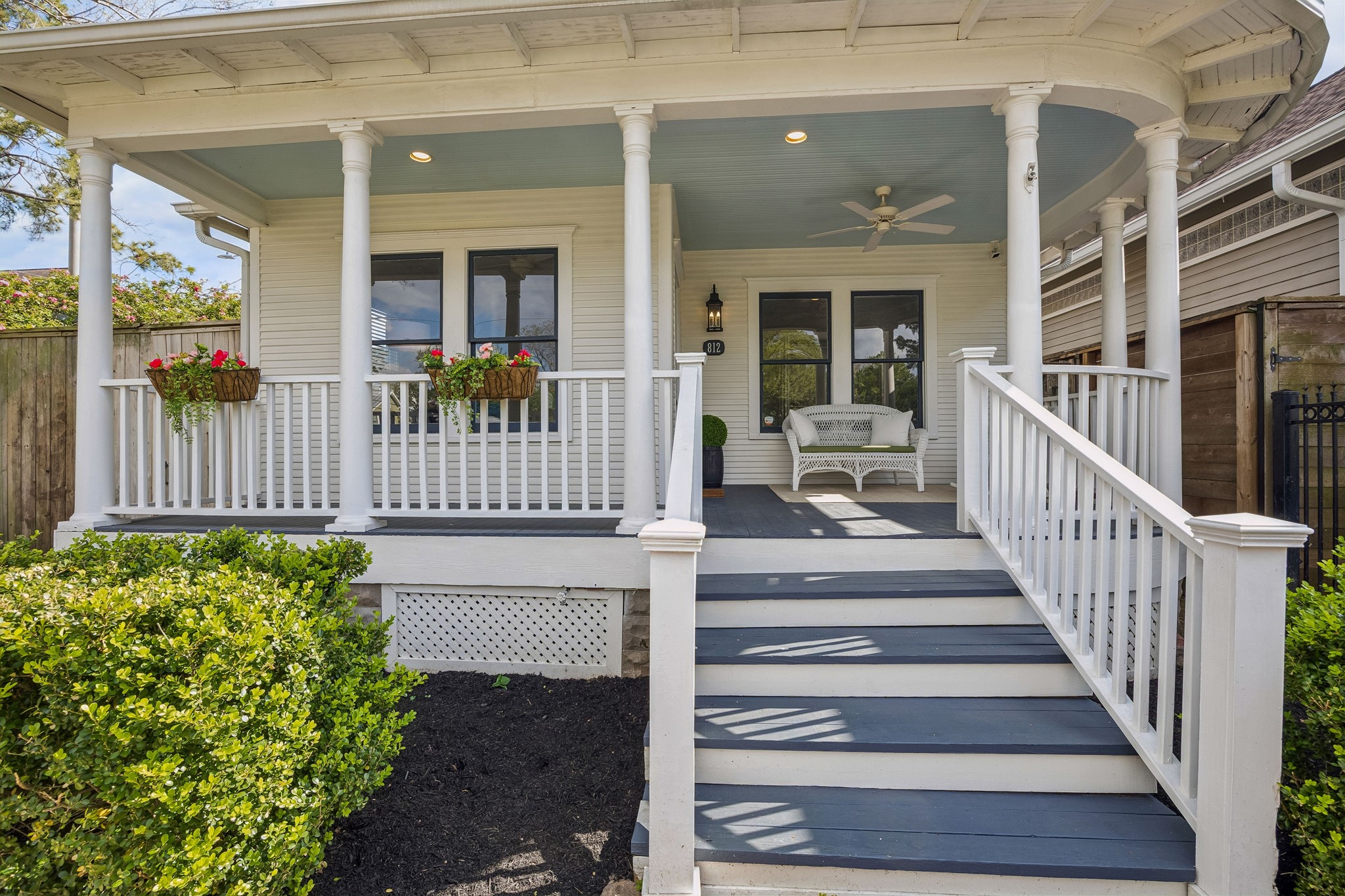 812 West 13th Street Houston, TX 77008 - Photo 8 of 29 Charming front porch with classic white railings and columns, featuring cozy seating and decorative flower boxes. Perfect for relaxing and enjoying the outdoors.