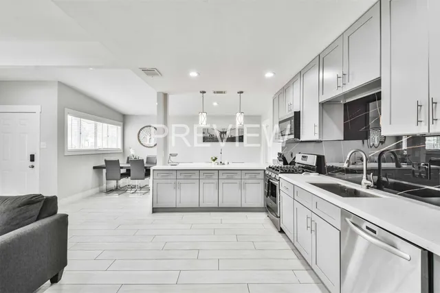 a kitchen with counter top space a sink cabinets and appliances
