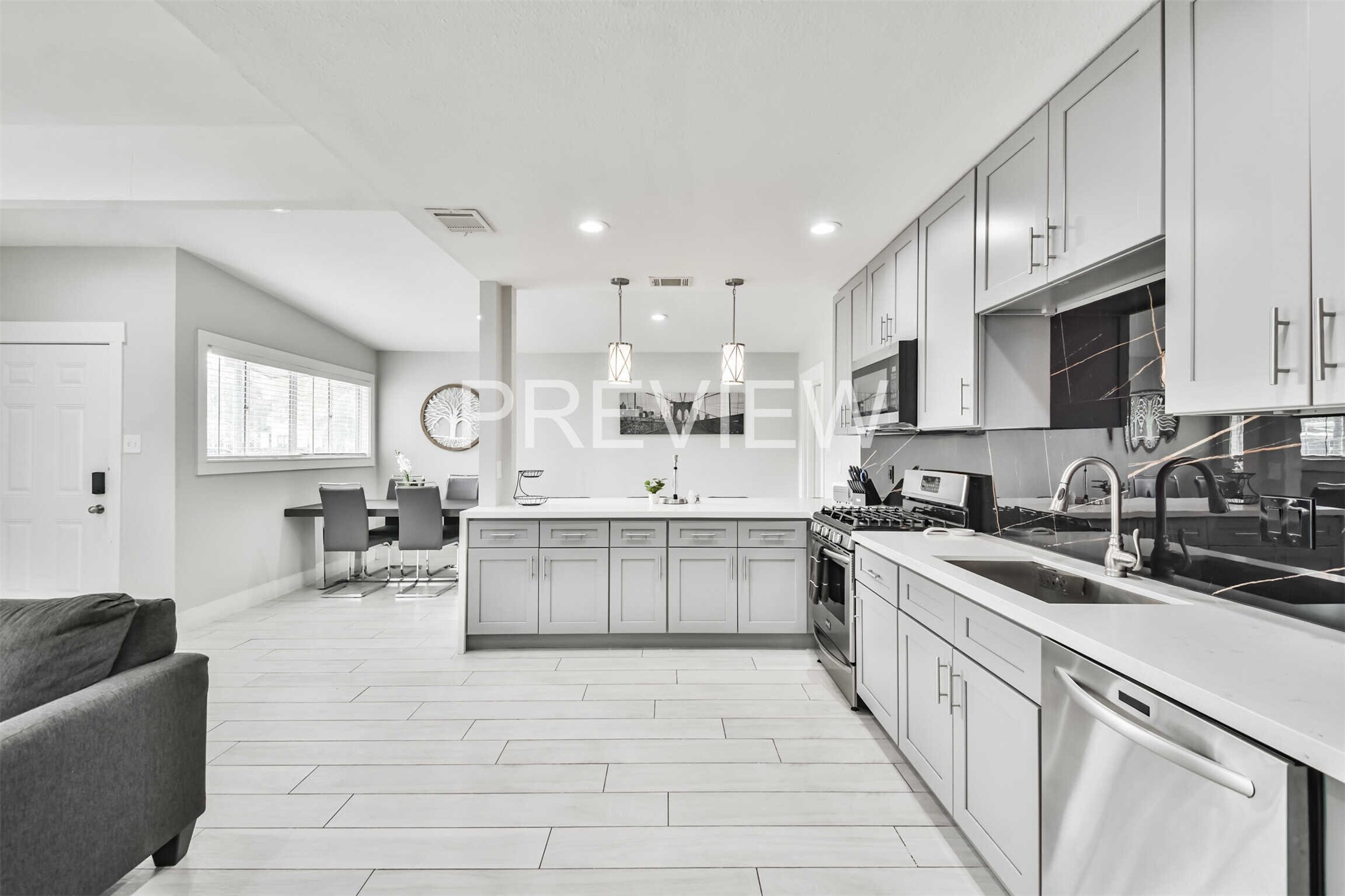 7522 Dearborn Street Houston, TX 77055 - Photo 18 of 39 a kitchen with counter top space a sink cabinets and appliances