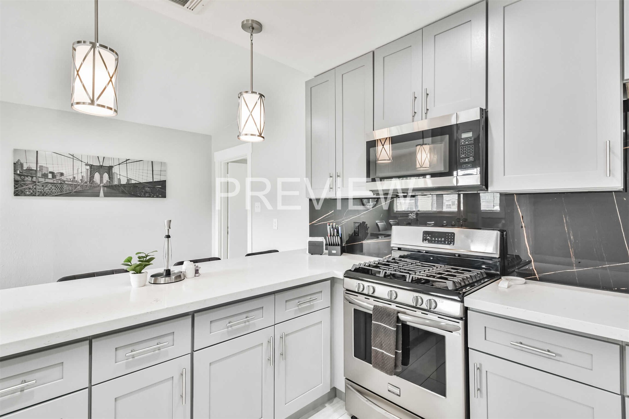 7522 Dearborn Street Houston, TX 77055 - Photo 21 of 39 a kitchen with granite countertop cabinets stainless steel appliances and wooden floor