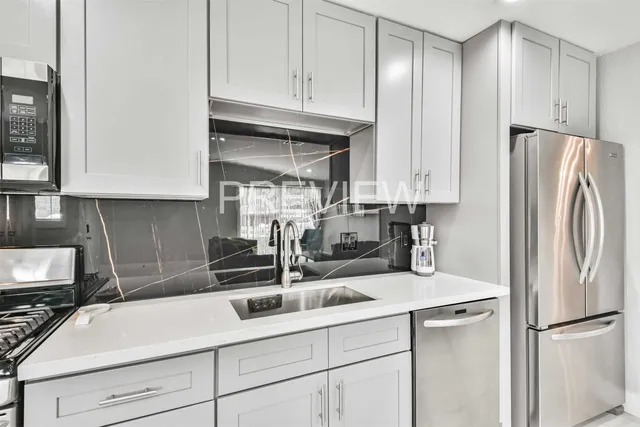 a kitchen with stainless steel appliances granite countertop a refrigerator sink and cabinets