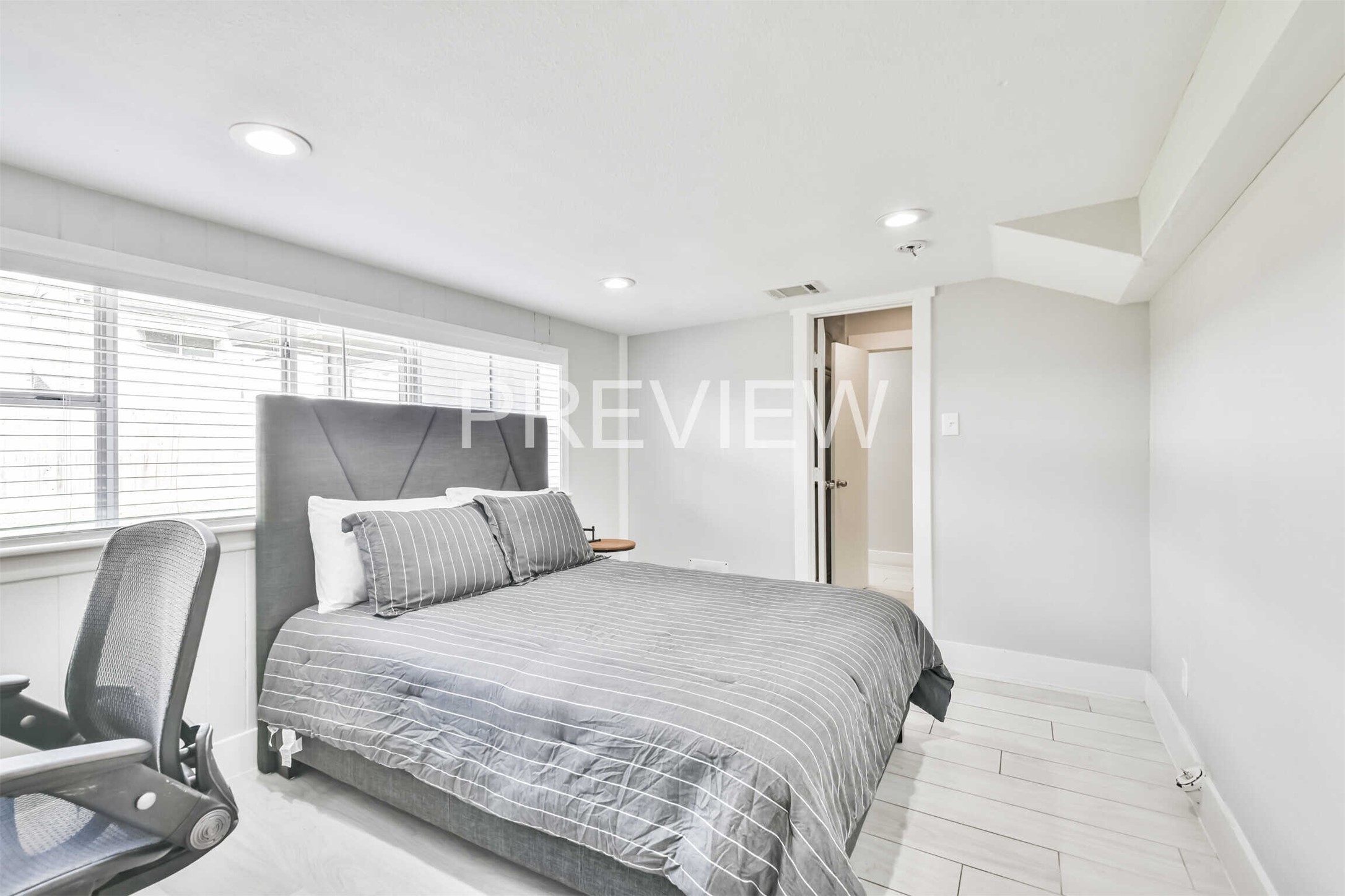 7522 Dearborn Street Houston, TX 77055 - Photo 27 of 39 a bedroom with a large bed and chair