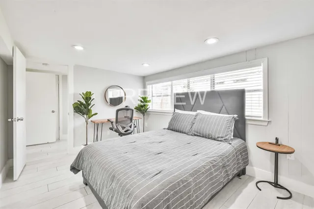 a bedroom with a bed and chandelier