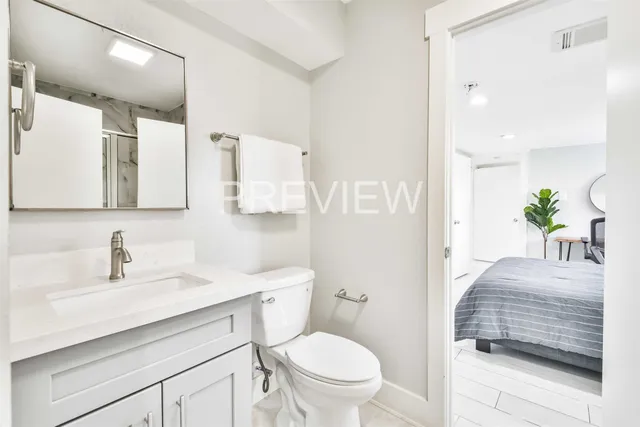 a bathroom with a sink a toilet and a mirror