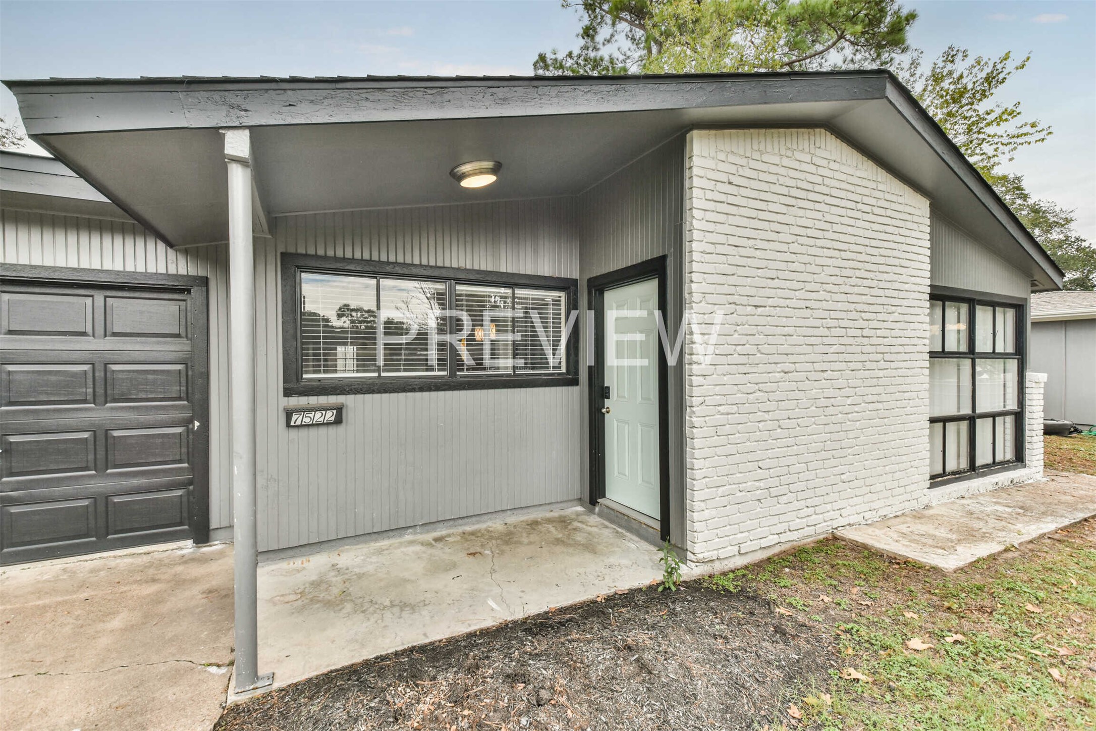 7522 Dearborn Street Houston, TX 77055 - Photo 3 of 39 a view of a house with a door and wooden walls