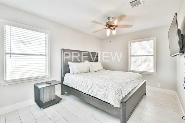 a large bed sitting in a bedroom next to a window