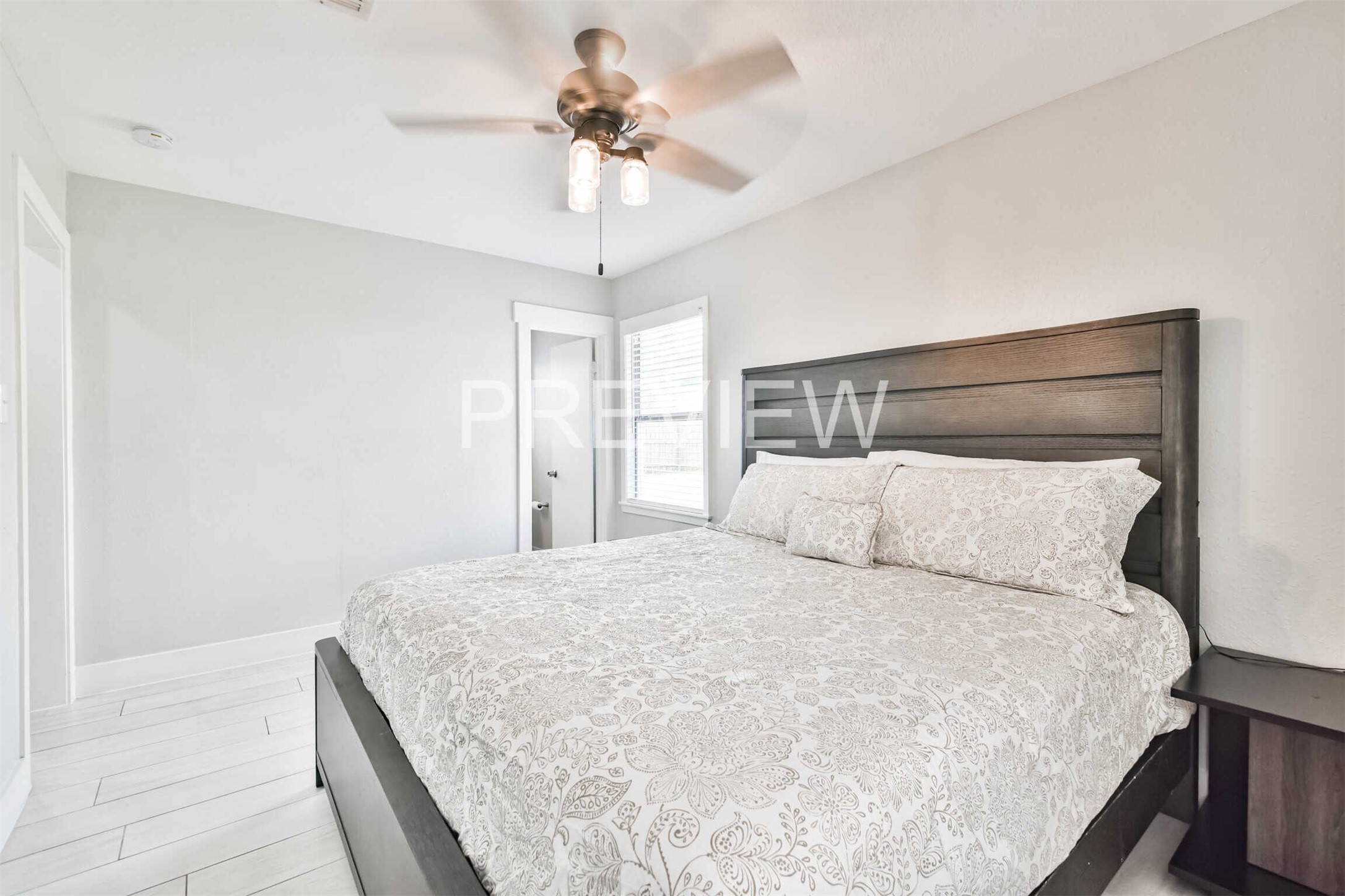 7522 Dearborn Street Houston, TX 77055 - Photo 32 of 39 a large bed sitting in a bedroom and a chandelier