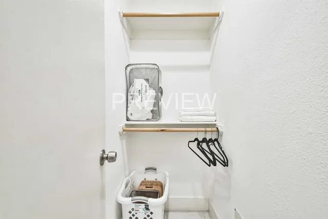 a picture of a bathroom with a window and cabinet