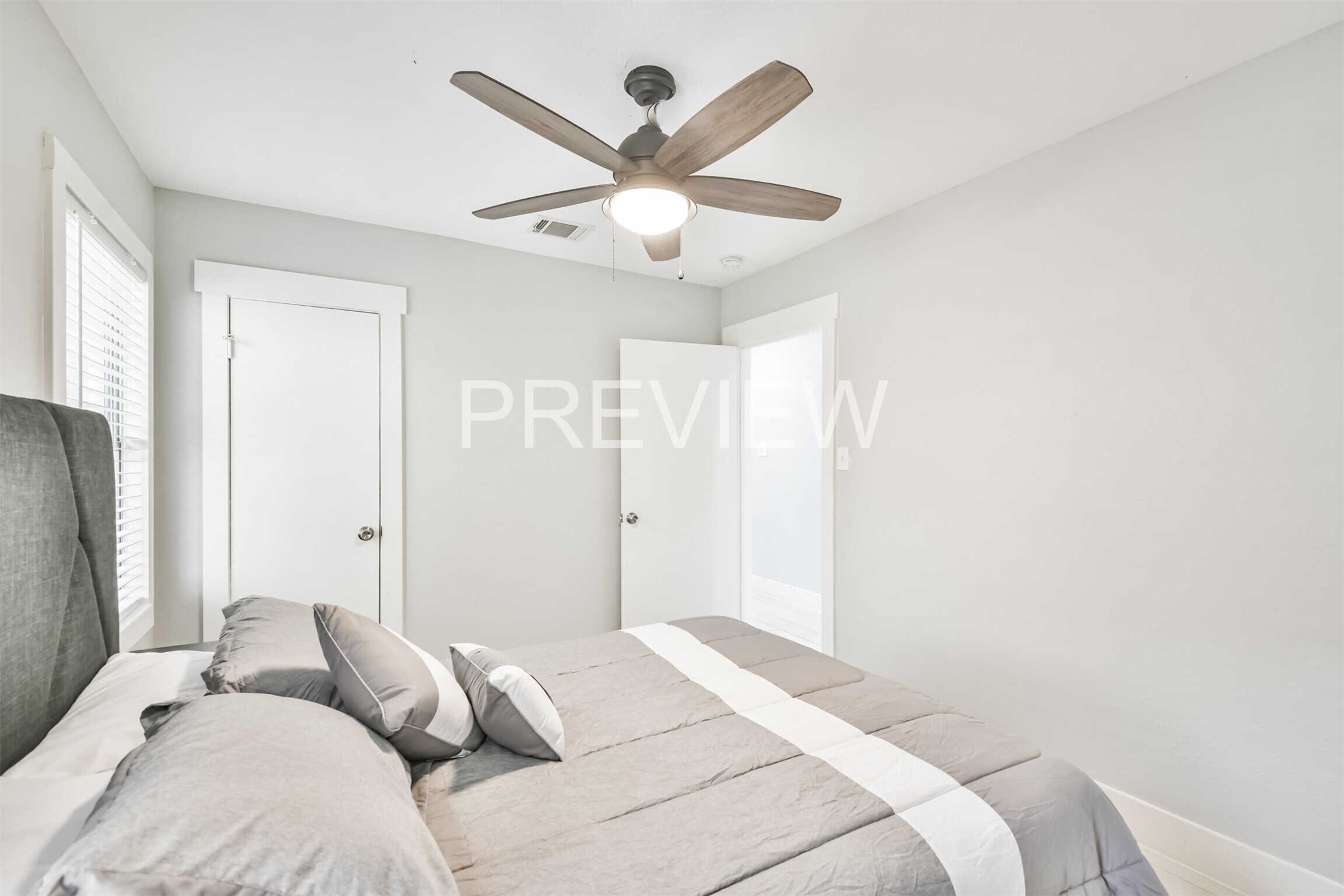 7522 Dearborn Street Houston, TX 77055 - Photo 37 of 39 a bedroom with a large bed and a chandelier