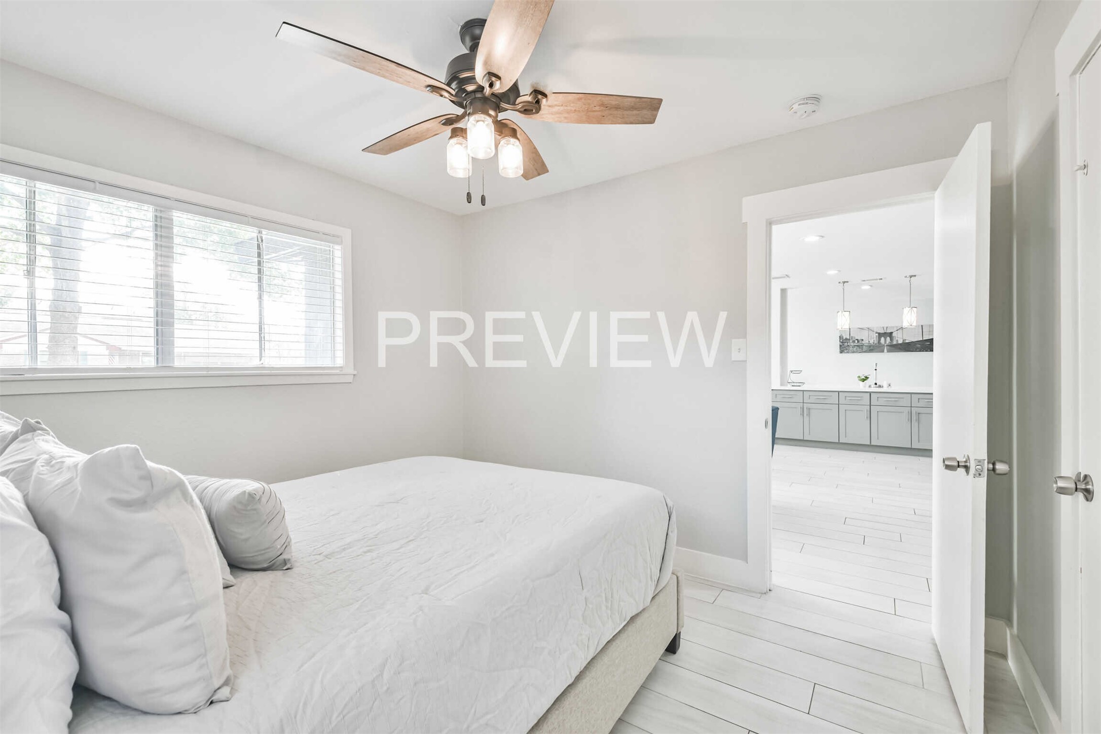 7522 Dearborn Street Houston, TX 77055 - Photo 39 of 39 a bedroom with a large bed and a chandelier