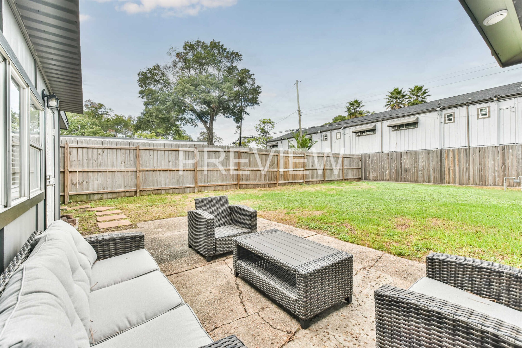 7522 Dearborn Street Houston, TX 77055 - Photo 9 of 39 a view of a patio with couches and a table and chairs with wooden fence