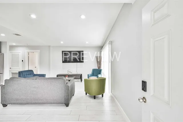 a living room with furniture and a potted plant