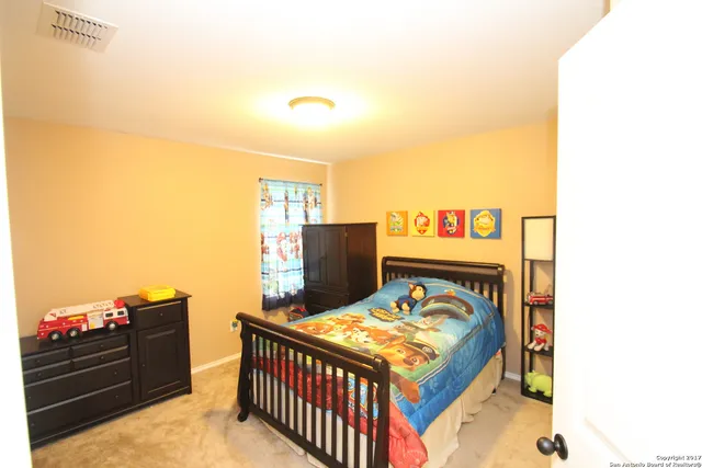 a bedroom with a bed and a dresser