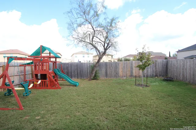 a view of outdoor space with playground and green space