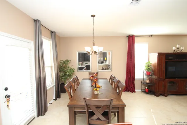 a dining room with furniture and window