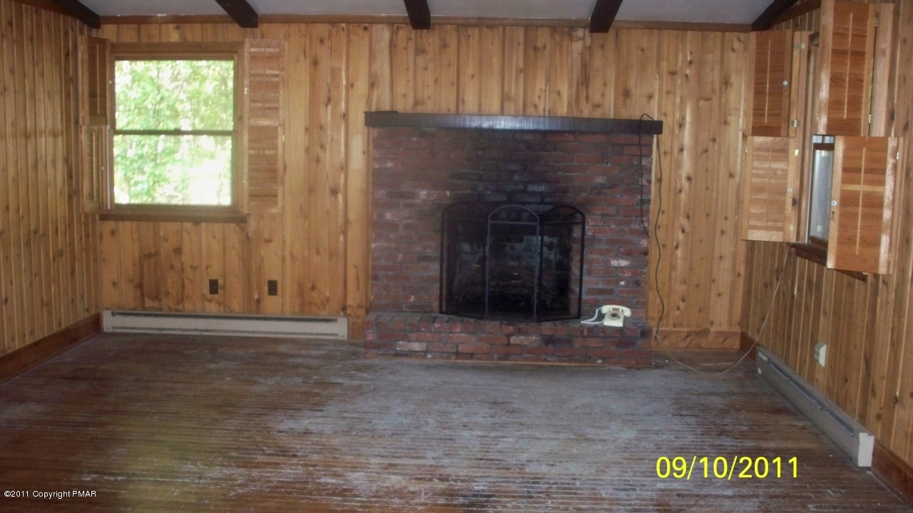 Lot 46 Pine Ridge Drive West Bushkill, PA 18324 - Photo 3 of 8 livingroom with fireplace & hrdwd floor