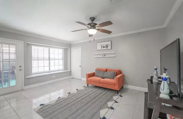 a white bath tub sitting in a bathroom next to a window