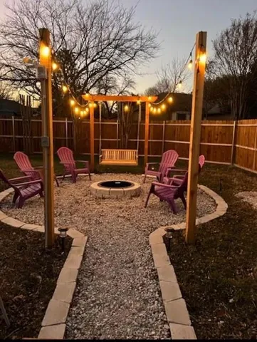 a view of a backyard with table and chairs