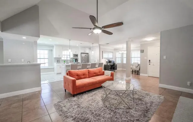 a living room with furniture and a view of kitchen
