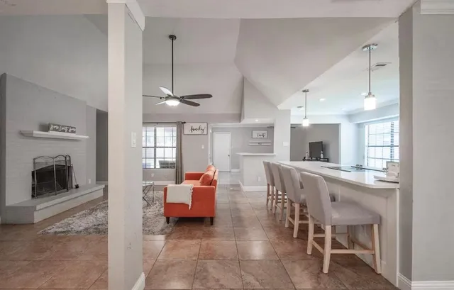 a living room with furniture a fireplace and a counter top space