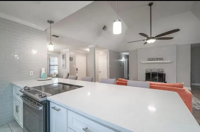 a kitchen with stainless steel appliances granite countertop a sink a stove and a refrigerator