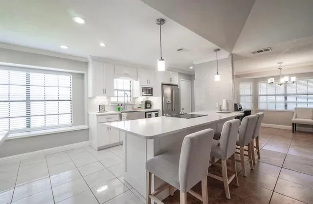 a large kitchen with a table and chairs
