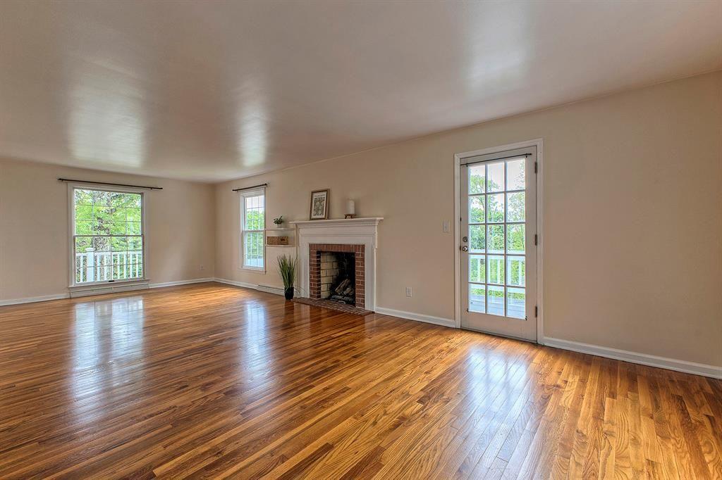 3222 Ridgeway Road Greensburg, PA 15601 - Photo 15 of 46 an empty room with wooden floor fireplace and windows