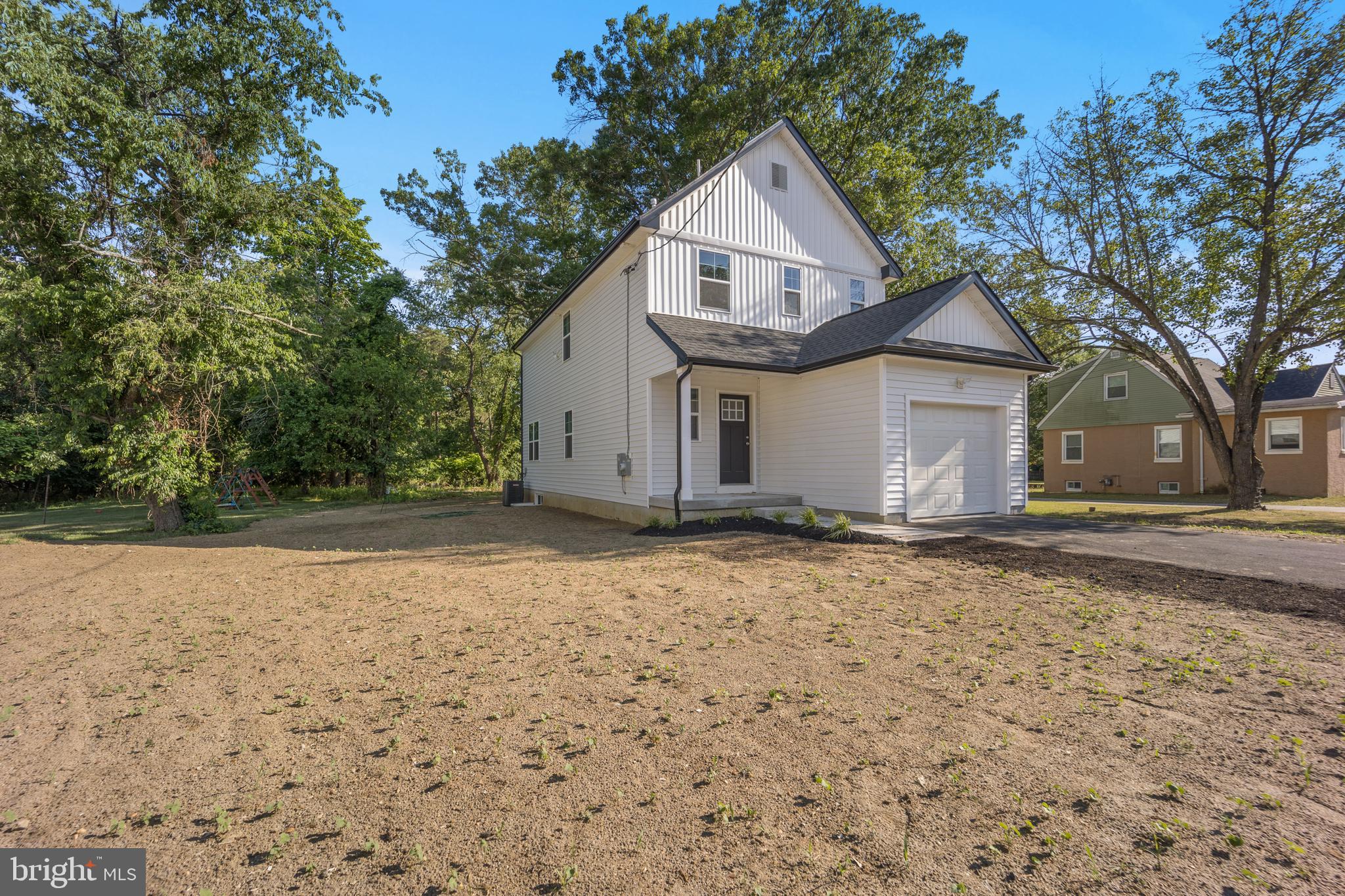 492 Ellis Avenue Lawnside, NJ 08045 - Photo 2 of 33 a view of a grey house with a yard