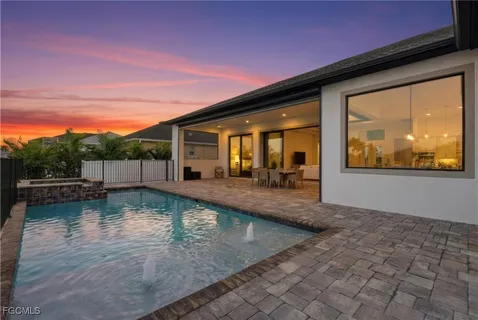 a view of a house with backyard and sitting area