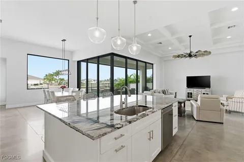 a living room with furniture or kitchen view and a chandelier