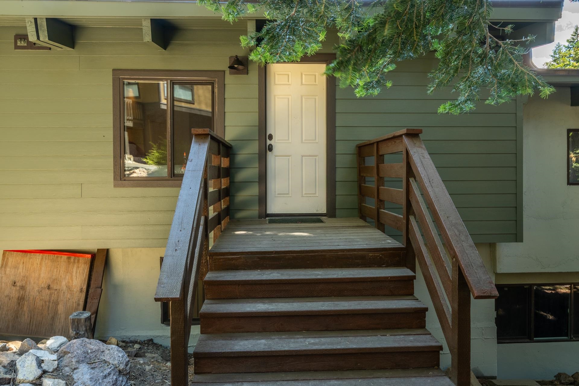 50 Hidden Valley Road, Unit 17 Mammoth Lakes, CA 93546 - Photo 19 of 40 Exterior entrance featuring a light-colored panel door, wood stairs with matching railings, and hori