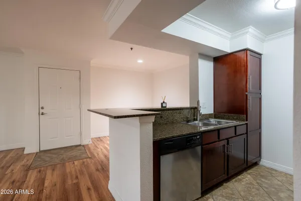 a kitchen with stainless steel appliances granite countertop a sink and a stove
