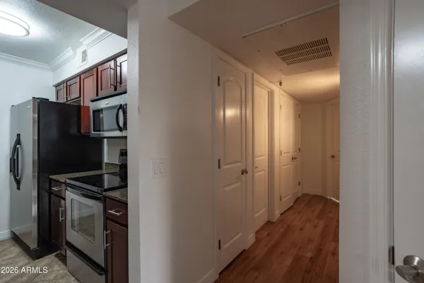 a view of a refrigerator and cabinets in a room