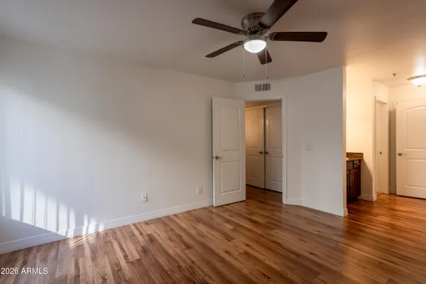 a view of empty room with wooden floor