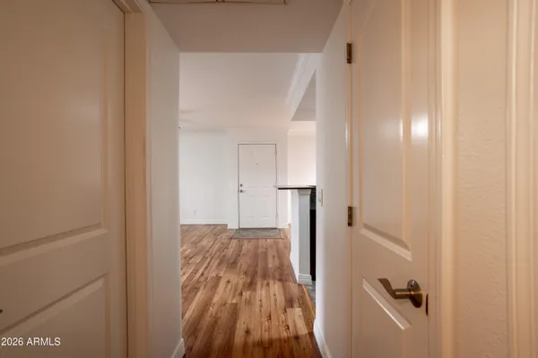 a view of a hallway with wooden floor