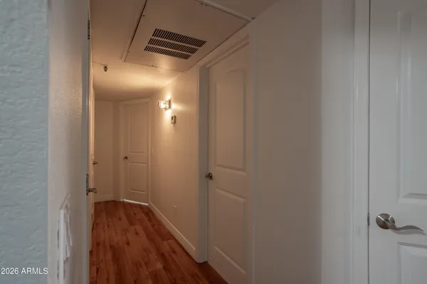 a view of hallway with wooden floor