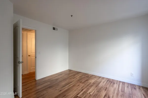 a view of an empty room and wooden floor