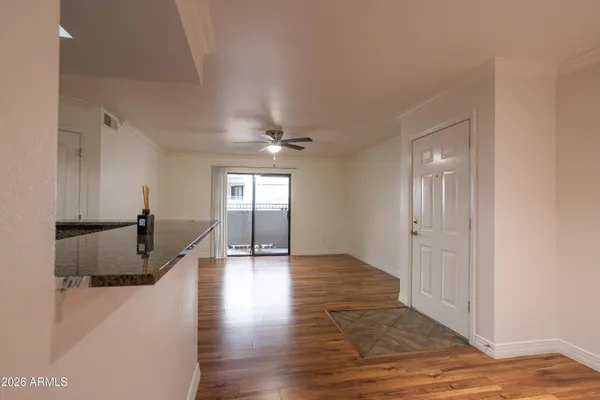 a view of a hallway with wooden floor
