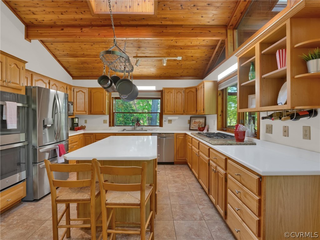 649 Kennsbury Road Hardyville, VA 23070 - Photo 15 of 50 a kitchen with stainless steel appliances kitchen island granite countertop a sink and wooden cabinets