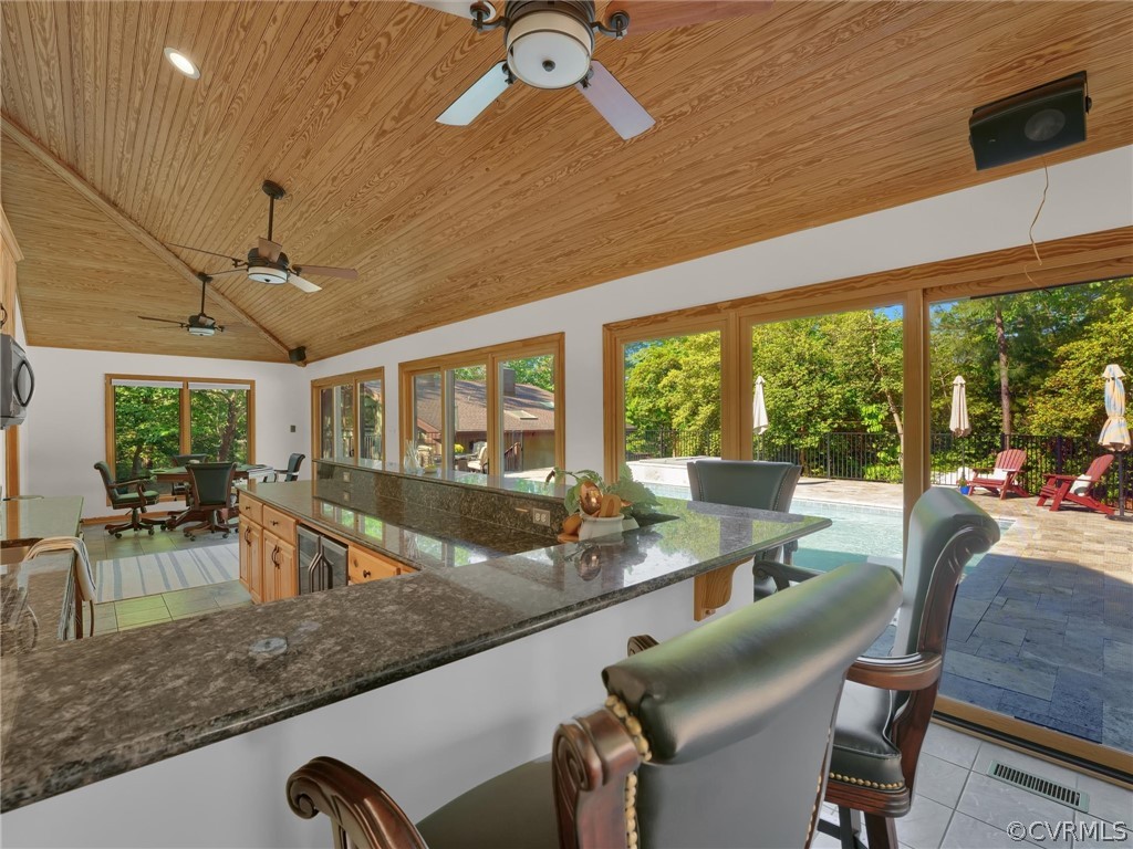 649 Kennsbury Road Hardyville, VA 23070 - Photo 39 of 50 a view of a dining room with furniture large windows and wooden floor