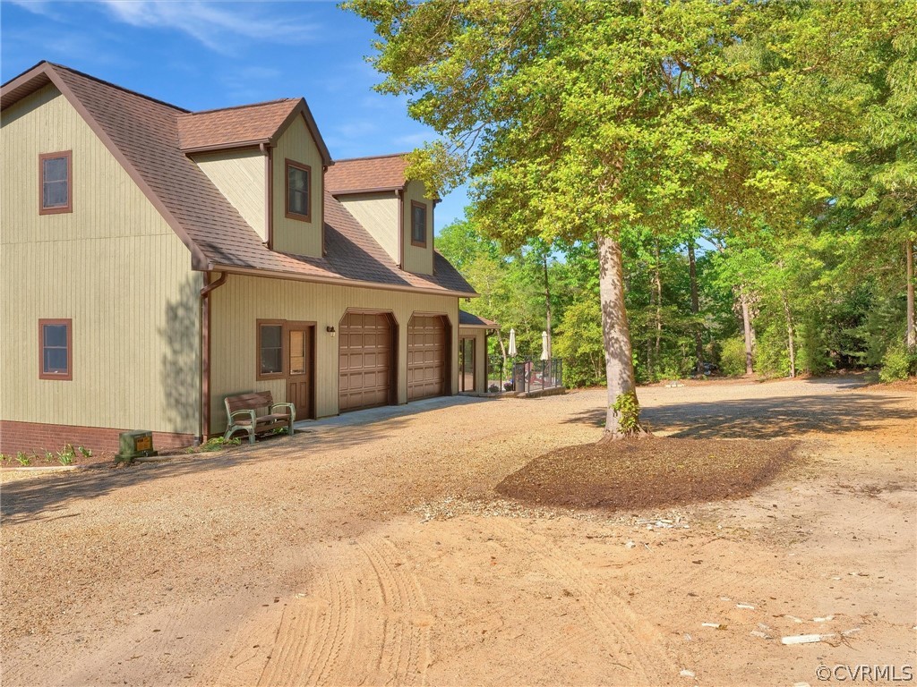 649 Kennsbury Road Hardyville, VA 23070 - Photo 48 of 50 a front view of a house with a yard and garage