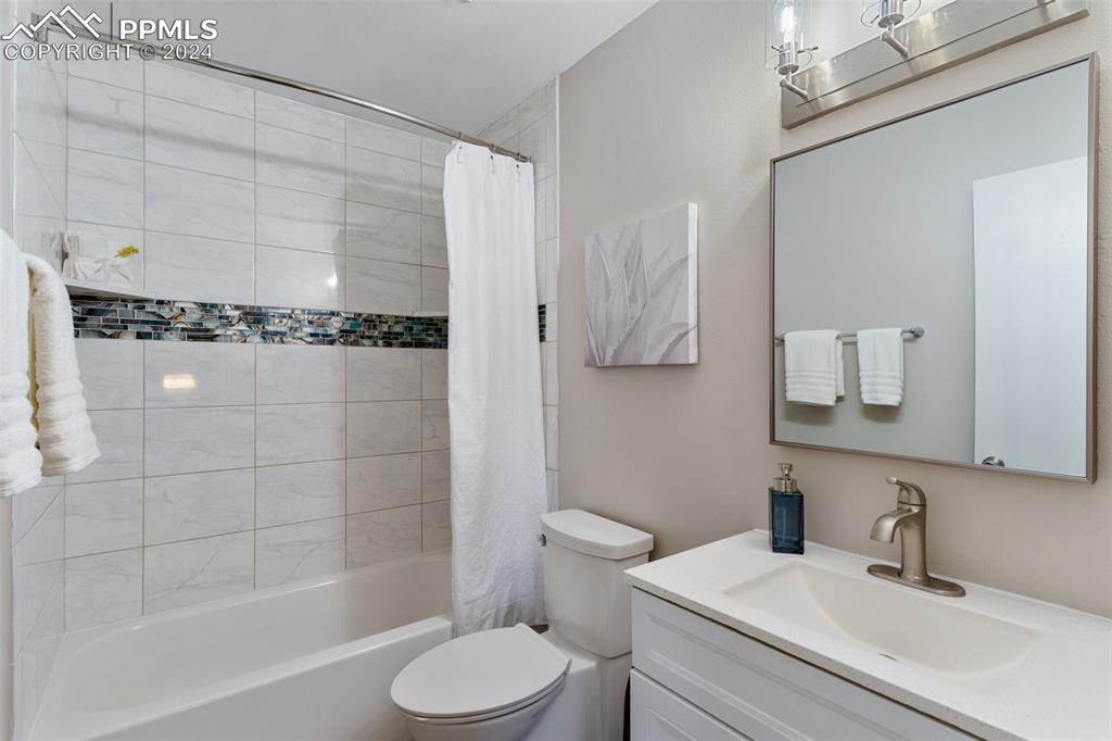 773 Alexander Road, Unit B Colorado Springs, CO 80909 - Photo 13 of 16 a bathroom with a sink a toilet and shower