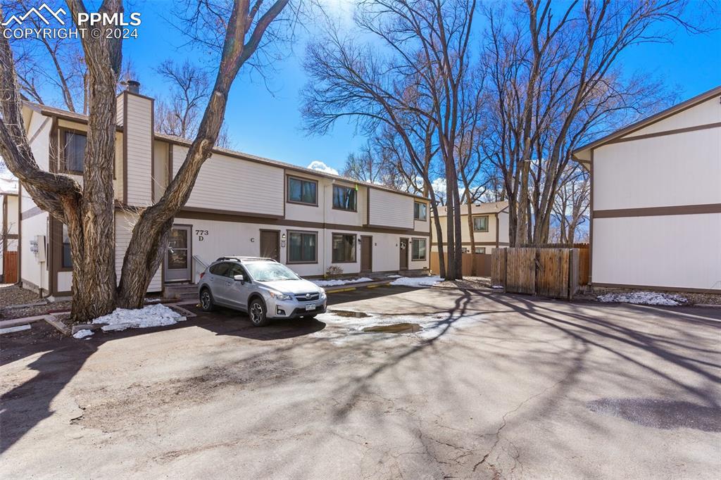 773 Alexander Road, Unit B Colorado Springs, CO 80909 - Photo 2 of 16 a front view of a house with a yard