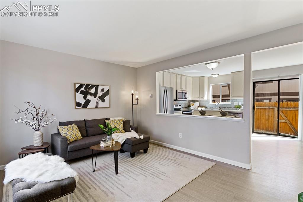 773 Alexander Road, Unit B Colorado Springs, CO 80909 - Photo 5 of 16 a living room with furniture and kitchen view
