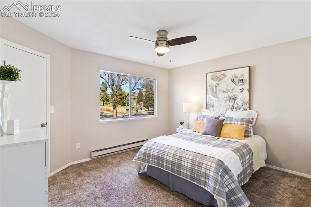 773 Alexander Road, Unit B Colorado Springs, CO 80909 - Photo 10 of 16 a bedroom with a bed and painting on the wall