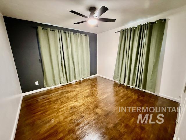 1139 Webster Street Clarkston, WA 99403 - Photo 15 of 34 Unfurnished room with wood finished floors and ceiling fan