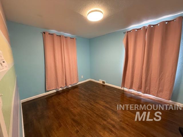 1139 Webster Street Clarkston, WA 99403 - Photo 18 of 34 Unfurnished room with dark wood finished floors and a textured ceiling
