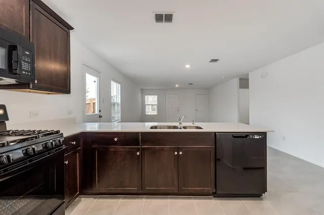 a kitchen with a sink and stainless steel appliances