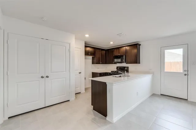 a kitchen with stainless steel appliances granite countertop a stove and a refrigerator